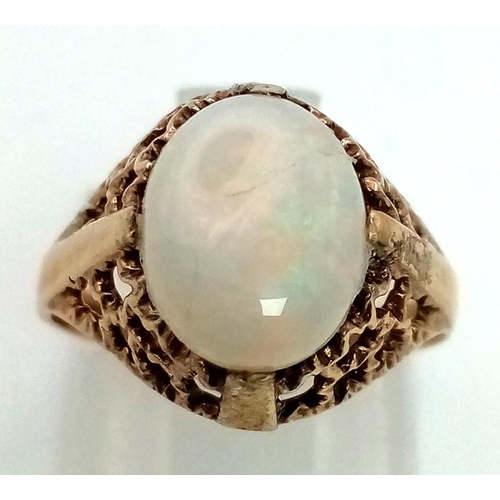 851 - A Vintage 9k gold ring set with 10mm by 8mm natural Australian opal. Size K. Weight 2.1g total.