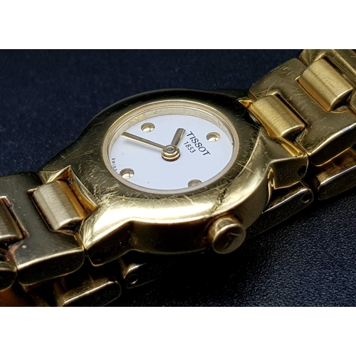 891 - A Tissot Gold Plated Ladies Quartz Watch. Gold plated strap and case - 20mm. White dial. Spare links... 