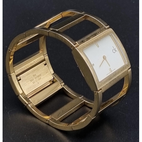 1003 - Calvin Klein CK gold tone bangle watch. Full working order, as found.