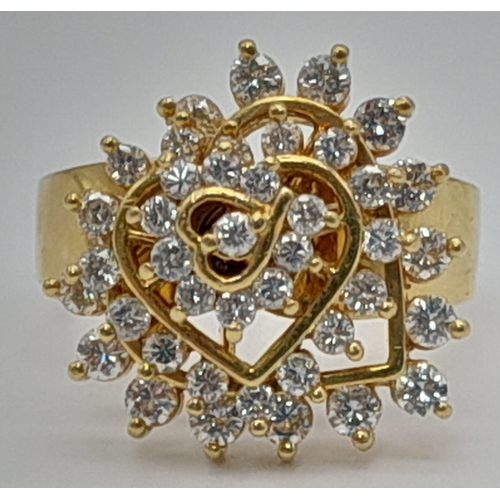 64 - 18k yellow gold diamond heart spinning cluster ring. 10.2g, 0.60ct, size N.