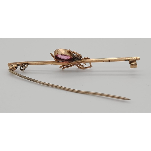 831 - 9k rose gold pink stone set spider brooch, 3g in weight.