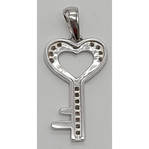 1007 - A 10K white gold, diamond set, key charm/pendant. weight: 1 g.