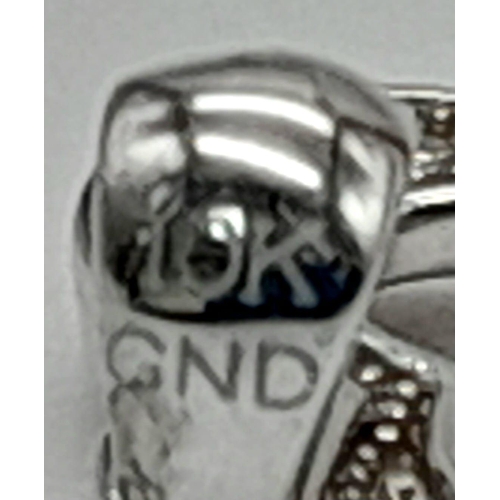 1007 - A 10K white gold, diamond set, key charm/pendant. weight: 1 g.