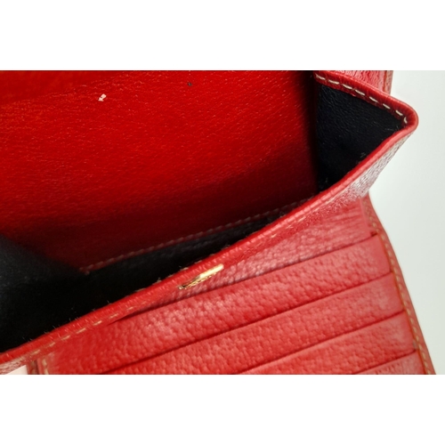 620 - A Gucci Monogram Canvas and Red Leather Wallet. 11 x 10cm. Ref: 10633.