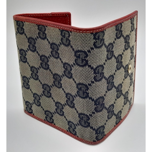 620 - A Gucci Monogram Canvas and Red Leather Wallet. 11 x 10cm. Ref: 10633.