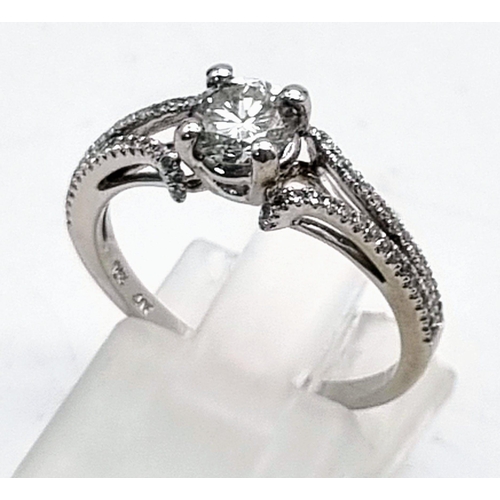 192 - 10k white gold diamond solitaire ring with diamond set split shoulders. 2.2g, 0.50ct, size M.