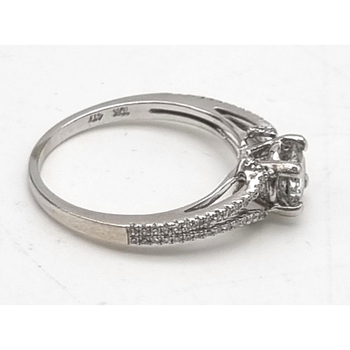 192 - 10k white gold diamond solitaire ring with diamond set split shoulders. 2.2g, 0.50ct, size M.