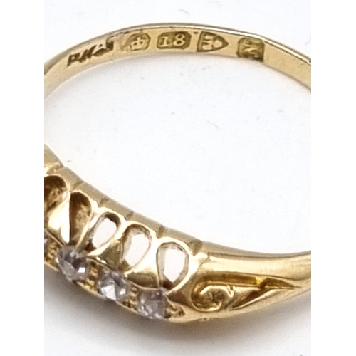 812 - AN 18K GOLD RING WITH 5 DIAMONDS IN CLASSIC STYLE.2.7gms  size O