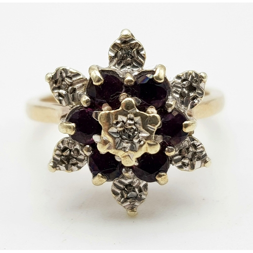 843 - 9k yellow gold diamond and garnet cluster ring. 3.6g, size K.