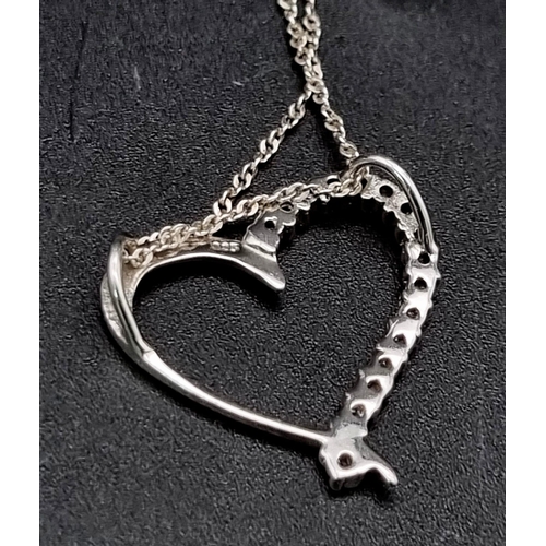 955 - Sterling silver heart pendant and chain. 2.4g in weight.