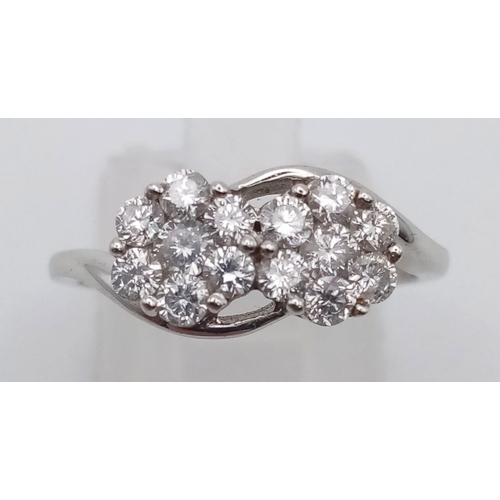 251 - An 18 K white gold ring with two diamond (0.69 carats) clusters. Ring size: M, weight: 3.2 g.