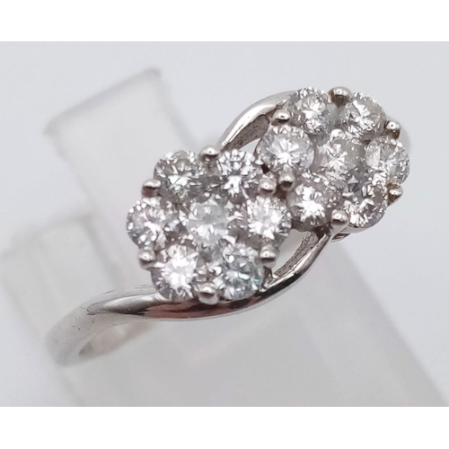 251 - An 18 K white gold ring with two diamond (0.69 carats) clusters. Ring size: M, weight: 3.2 g.