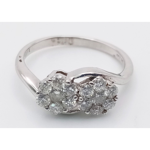 251 - An 18 K white gold ring with two diamond (0.69 carats) clusters. Ring size: M, weight: 3.2 g.