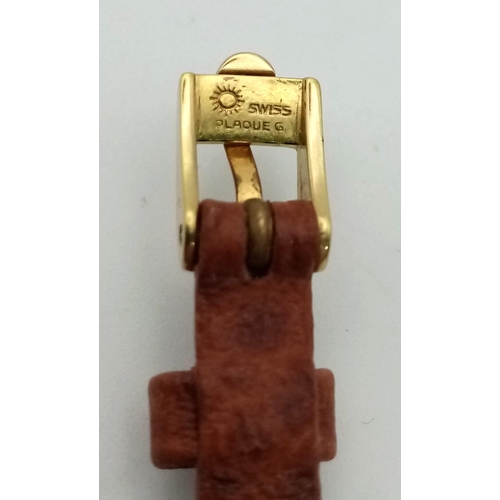 397 - A DAINTY VINTAGE 18K GOLD LADIES OMEGA WRIST WATCH ON THE ORIGINAL OMEGA LEATHER STRAP. MANUAL MOVEM... 