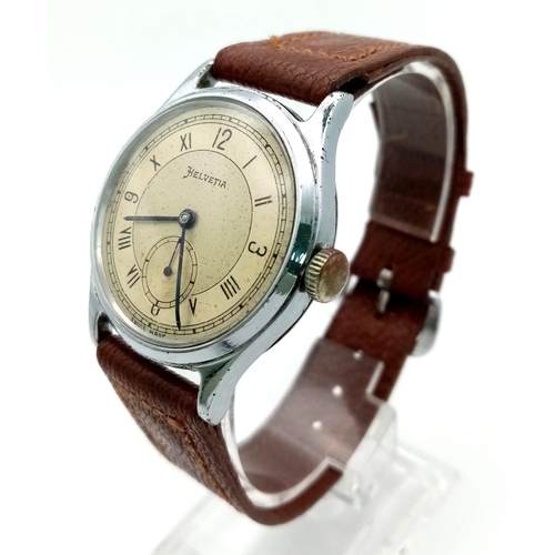 439 - A VINTAGE HELVETIA WRIST WATCH WITH SECOND HAND SUBDIAL AND LEATHER STRAP . FWO  34mm