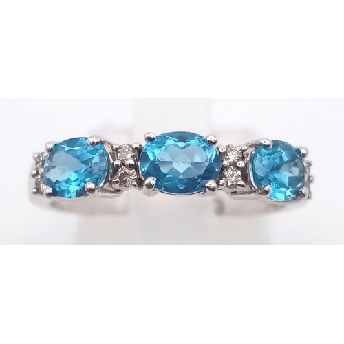 509 - An 18 K white gold ring with diamonds and London Blue topaz. Ring size: N, weight: 2.6 g.