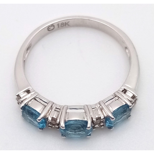 509 - An 18 K white gold ring with diamonds and London Blue topaz. Ring size: N, weight: 2.6 g.