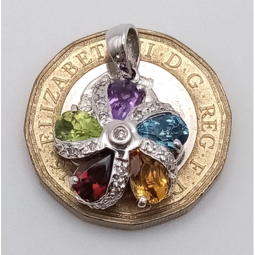 552 - A 9 K white gold, flower pendant with diamonds and peridot, garnet, citrine, aquamarine and amethyst... 