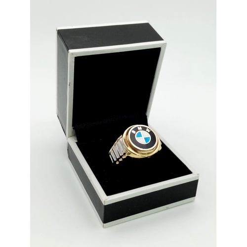 861 - A 14 K yellow gold ring with white gold highlights and the BMW logo on top. Ring size: Y, weight: 5.... 