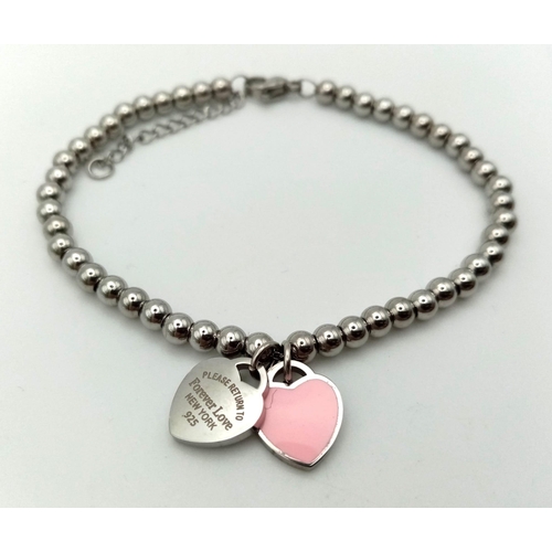 924 - White metal pink heart Forever Love bracelet. 11.3g in total.