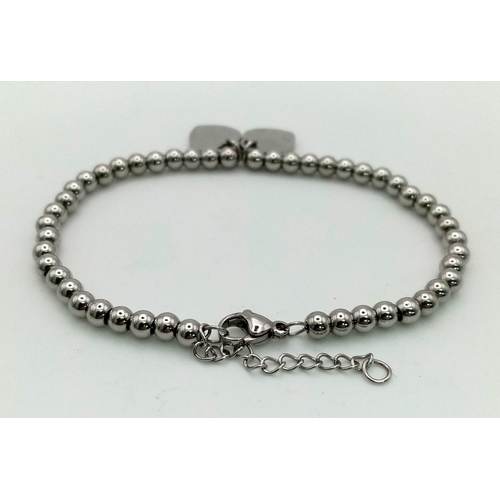 924 - White metal pink heart Forever Love bracelet. 11.3g in total.