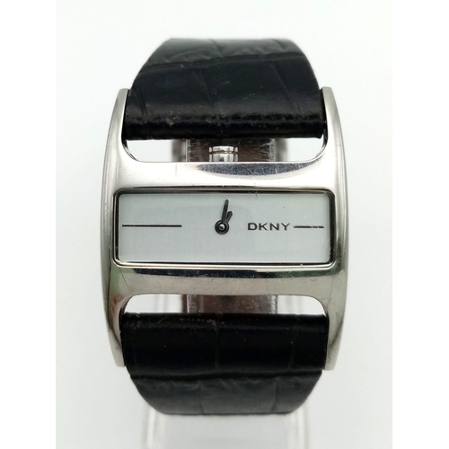 941 - DKNY black leather strap watch. As found.