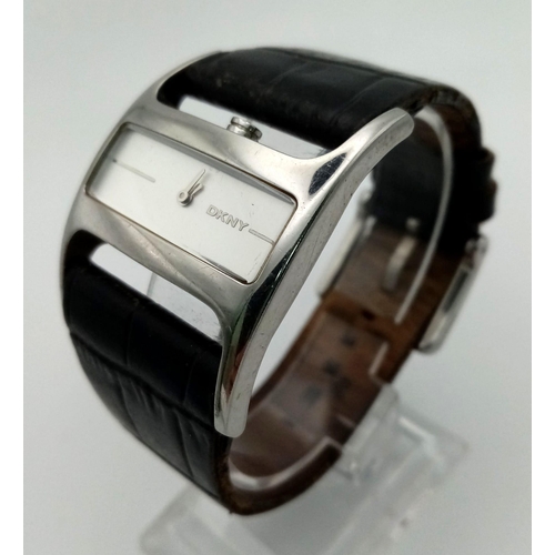 941 - DKNY black leather strap watch. As found.