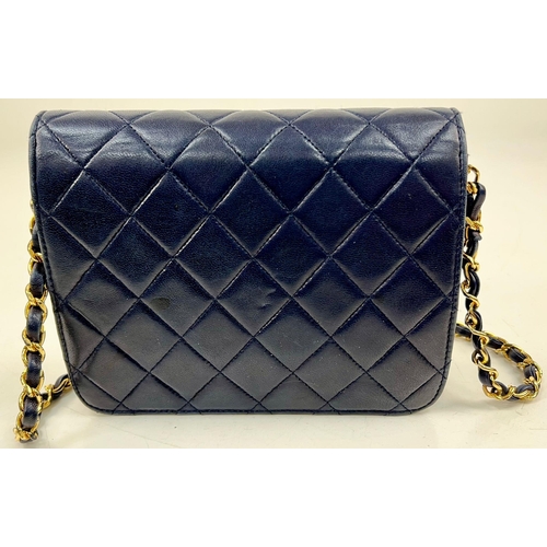 122 - A Vintage Chanel Mini Flap Handbag. Blue quilted lambskin. Gold-tone hardware with CC lock. Interior... 