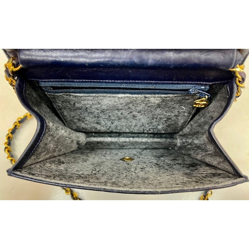 122 - A Vintage Chanel Mini Flap Handbag. Blue quilted lambskin. Gold-tone hardware with CC lock. Interior... 