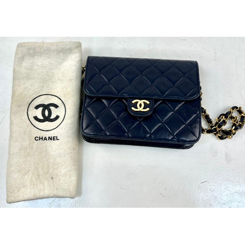 122 - A Vintage Chanel Mini Flap Handbag. Blue quilted lambskin. Gold-tone hardware with CC lock. Interior... 