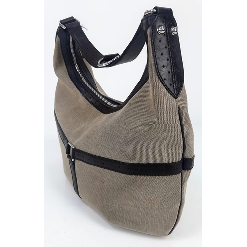 266 - A Gucci Reins Web Hobo Canvas Bag. Beige canvas and brown leather in a cross shape. Silver-tone hard... 