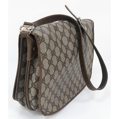 606 - A Gucci Monogram Canvas and Leather Shoulder Bag. Multiple zipped and open interior compartments. Re... 