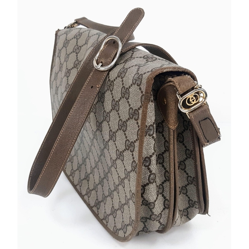 606 - A Gucci Monogram Canvas and Leather Shoulder Bag. Multiple zipped and open interior compartments. Re... 