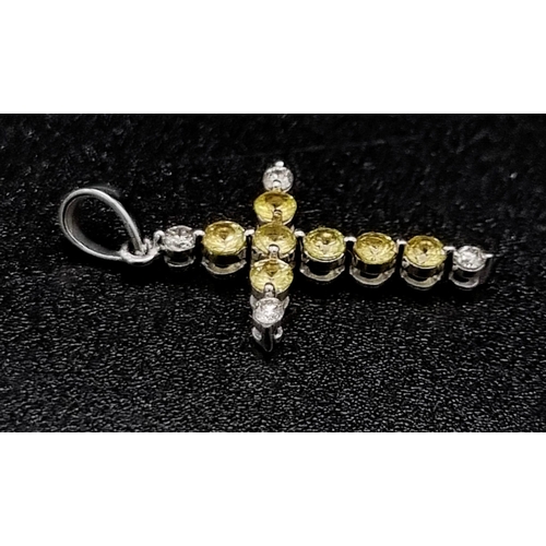 623 - 19k white gold diamond and yellow sapphire cross pendant. 1g in weight.