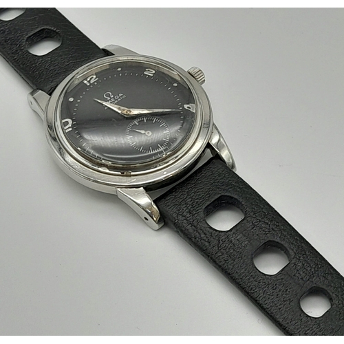 285 - AN OMEGA AUTOMATIC WRIST WATCH, MANUAL MOVEMENT, BLACK FACE AND STRAP.  36mm