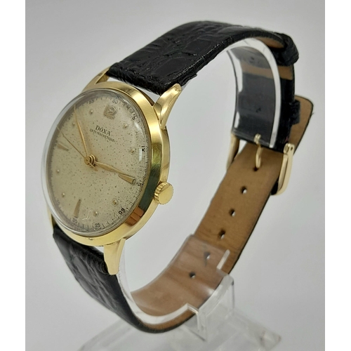 404 - A 14K GOLD DOXA VINTAGE WRIST WATCH 1950/60'S MODEL MANUAL MOVEMENT ON A BLACK LEATHER STRAP. 35mm