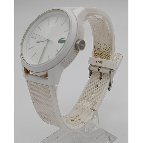 819 - A LACOSTE LADIES WRIST WATCH IN WHITE WITH QUARTZ MOVEMENT.  42mm