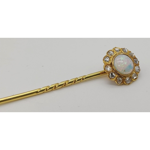 376 - An Antique High Karat Gold Opal and Diamond Stick Pin. Central floral opal with twelve surrounding d... 