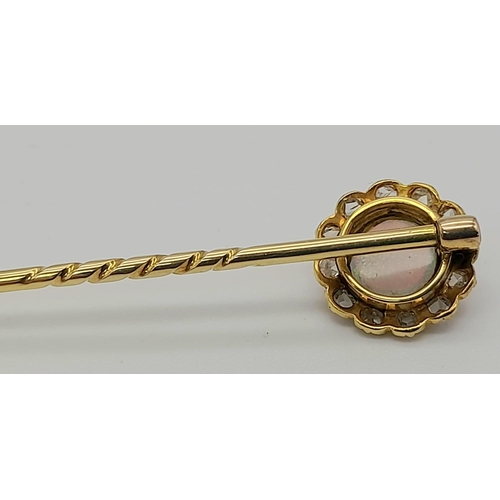 376 - An Antique High Karat Gold Opal and Diamond Stick Pin. Central floral opal with twelve surrounding d... 