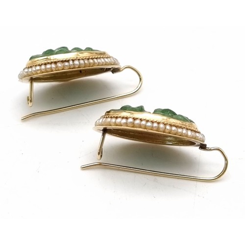 639 - A vintage 14 k yellow gold pair of earrings with carved oval jade surrounded by seed natural pearls.... 