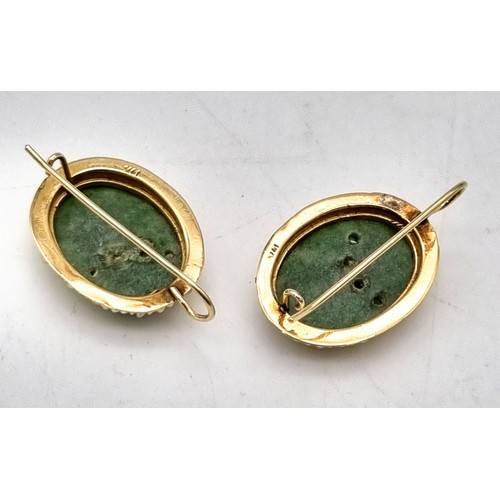 639 - A vintage 14 k yellow gold pair of earrings with carved oval jade surrounded by seed natural pearls.... 