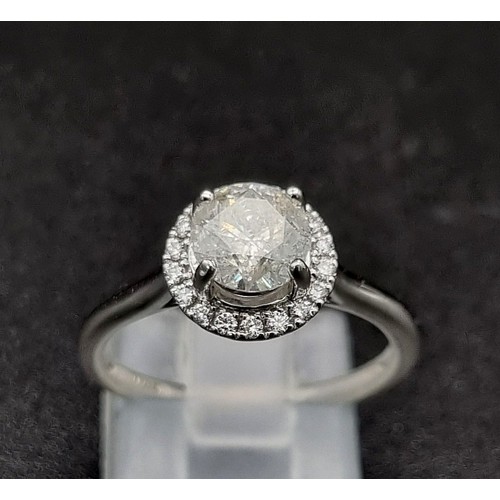 57 - 18k white gold halo solitaire ring. Approximately 1ct centre diamond, 3.6g, size M.