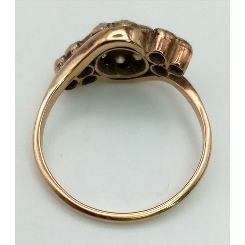 47 - An Antique 15K Rose Gold Diamond Crossover Ring. Central diamond with a halo of diamonds - 1ct. Fift... 