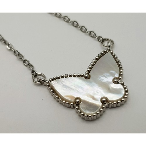 917 - White metal butterfly pendant on chain. 2.8g in weight.