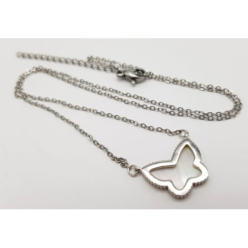 917 - White metal butterfly pendant on chain. 2.8g in weight.