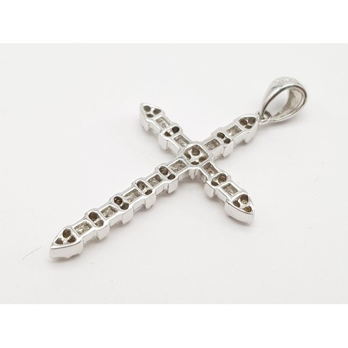 244 - 18k white gold diamond set cross. 0.70ct, 2.8g.