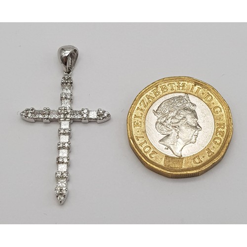 244 - 18k white gold diamond set cross. 0.70ct, 2.8g.