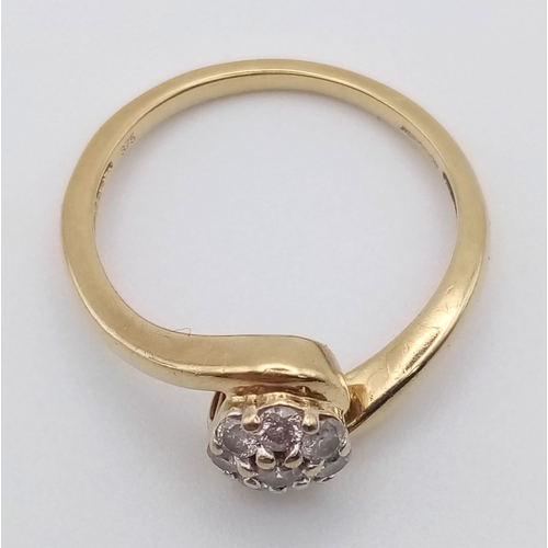 474 - A 9K Yellow Gold Diamond Cluster Crossover Ring. Eight diamonds. Size N. 2.23g total weight