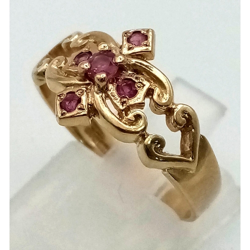 753 - An Art Nouveau 9K Yellow Gold Five Ruby Gemstone Cross Ring. Size Q.  2.75g total weight.