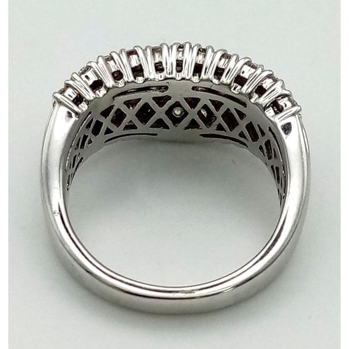 171 - An 18 K white gold ring with wavy band of baguette cut diamonds accompanied by further two bands of ... 